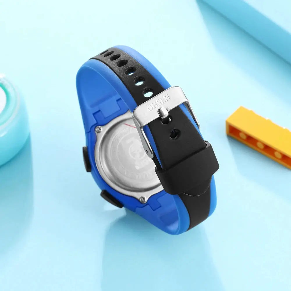 Alcom Distribution kids sport digital watch with blue and black adjustable strap shown from the back
