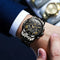 OLEVS waterproof quartz watch with black metal band and gold accents on wrist