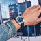Pagani Design diver watch with blue dial and leather strap worn on wrist in urban setting