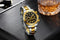 Stylish waterproof stainless steel chronograph watch with black dial and gold accents on a textured surface
