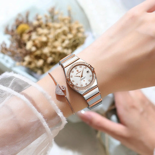 Luxury quartz watch for women with silver and rose gold band worn on wrist with delicate bracelet