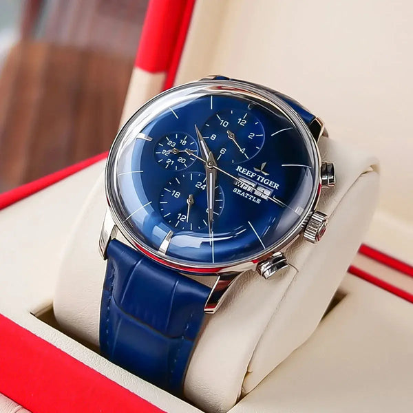 Reef Tiger luxury men's watch with blue dial and leather strap displayed in a cream and red box