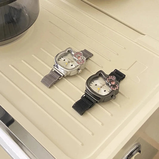 Alcom Distribution hello kitty diamond watch duo with silver and black mesh bands and pink crystal bow accents