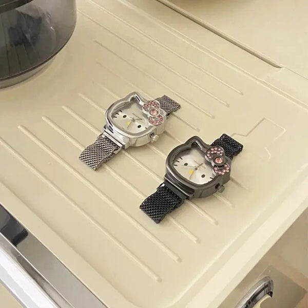 Alcom Distribution hello kitty diamond watch duo with silver and black mesh bands and pink crystal bow accents
