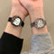 Alcom Distribution hello kitty diamond watch on two wrists showing black and silver mesh bands jeweled bow and Hello Kitty face
