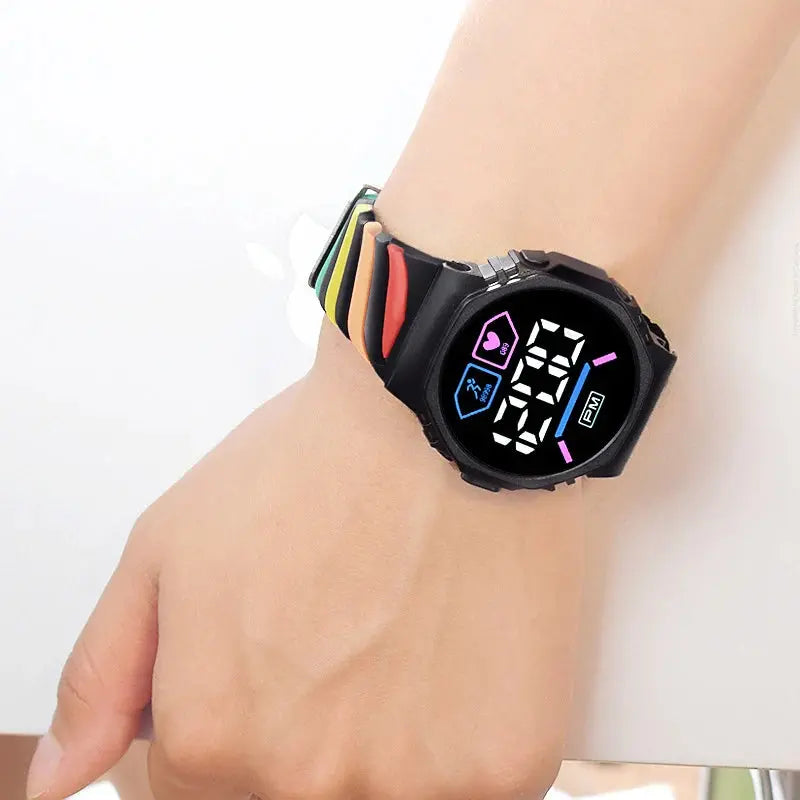 Silicone rainbow watch for children with black digital face and colorful strap on wrist