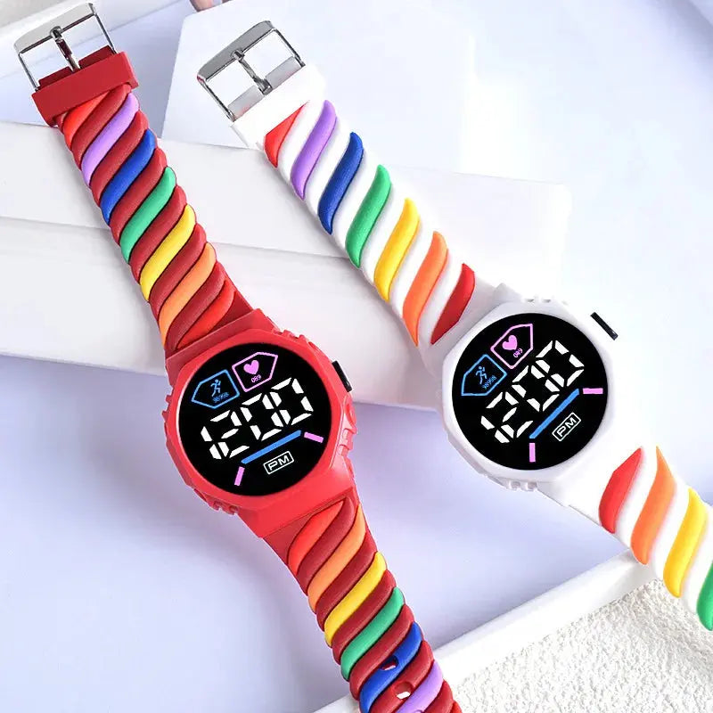 Silicone rainbow watch for children featuring colorful twisted bands and digital display by Alcom Distribution