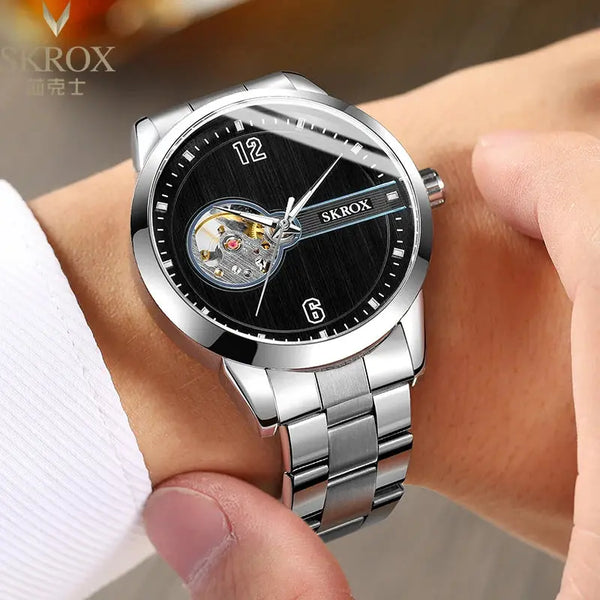 SKROX waterproof automatic watch with silver metal band and black dial on wrist
