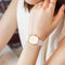 Elegant waterproof quartz watch with white band and gold-tone square case by Alcom Distribution