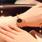 Alcom Distribution retro gold bangle watch with black dial on wrist styled with delicate bracelet