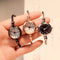 Alcom Distribution retro gold bangle watch with round dial and twisted metal band in black silver and rose gold